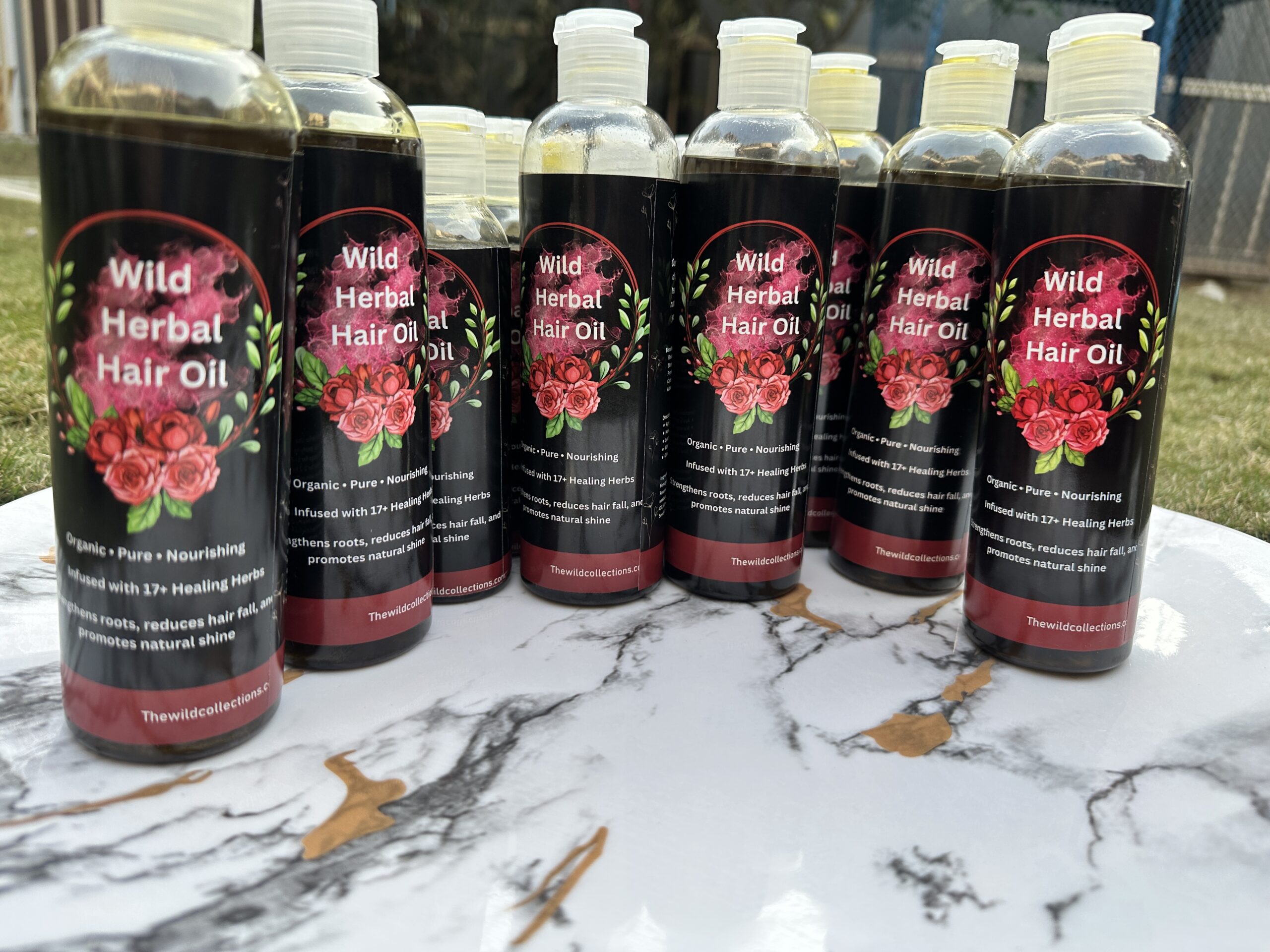 natural-herbal-hair-oil-17-herbs-hair-fall-control-bottles.jpg Wild herbal hair oil bottle held in hand, 17 herbs, no heat extraction